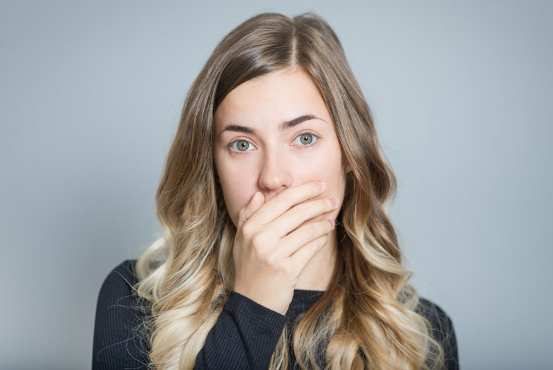 Dental Patient Shyly Hiding Her Missing Tooth
