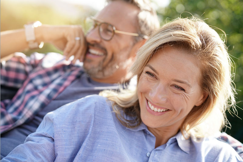 Two Full Arch Dental Implant Patients Smiling Together