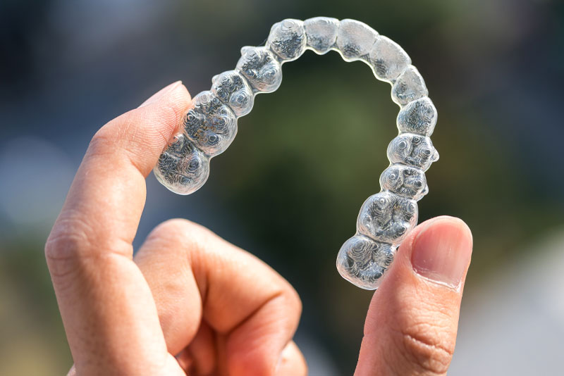 Invisalign Model Being Held Up