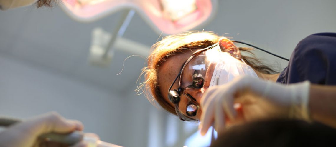 Dentist Performing A Gum Recession Treatment Procedure